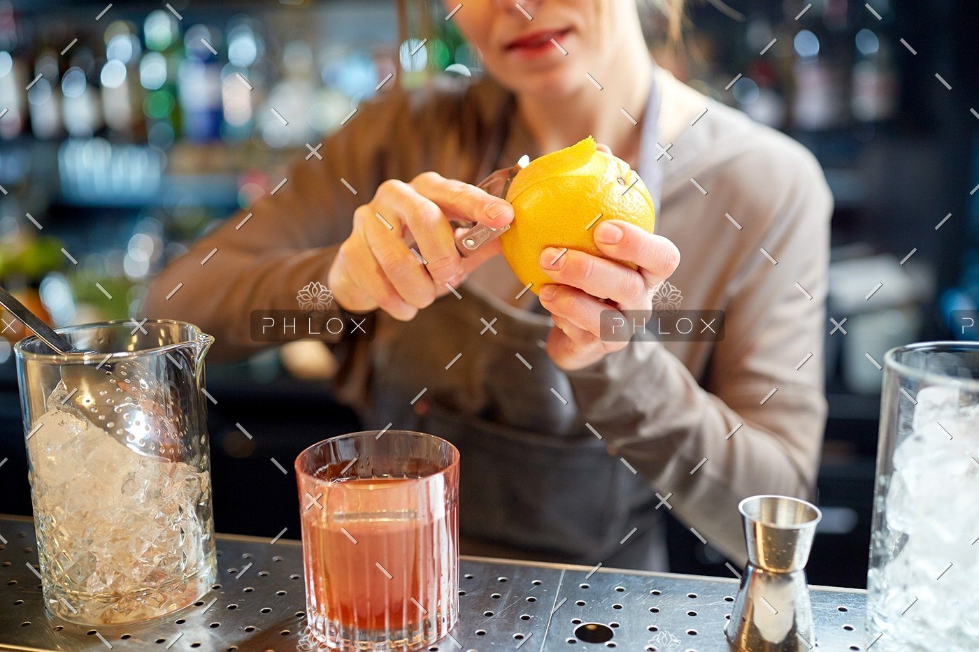demo-attachment-18-bartender-peels-orange-peel-for-cocktail-at-bar-P97775Y